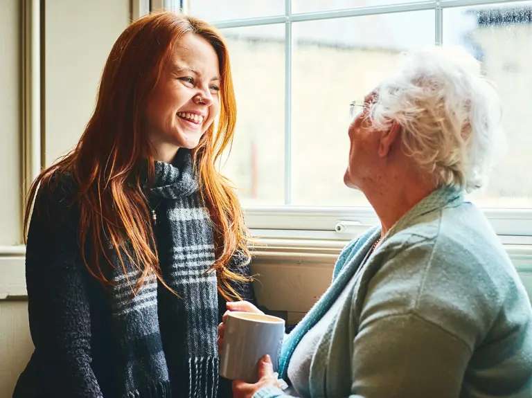 Young Girl Talking To Older Lady